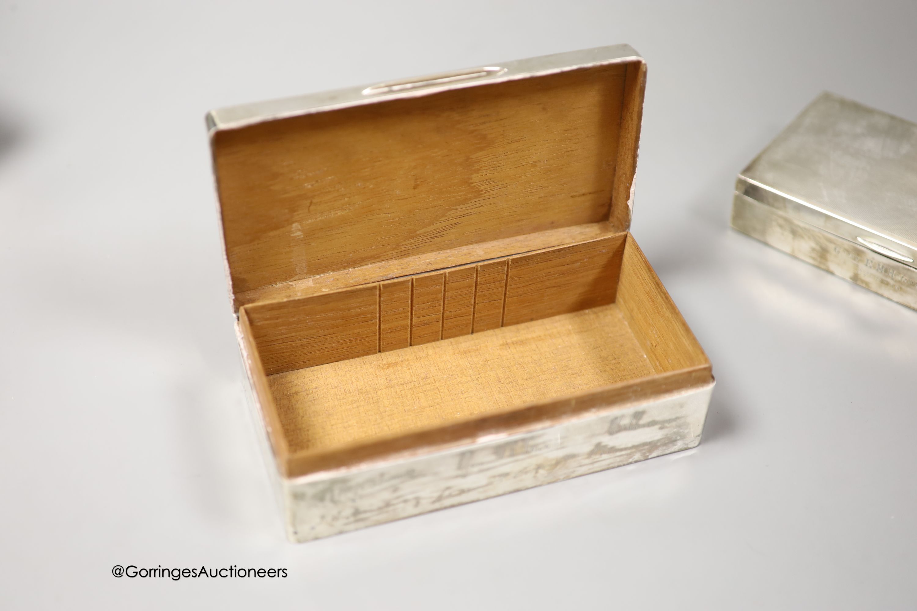 Three 20th century silver mounted cigarette boxes, two with engraved signatures, largest 16.2cm.
